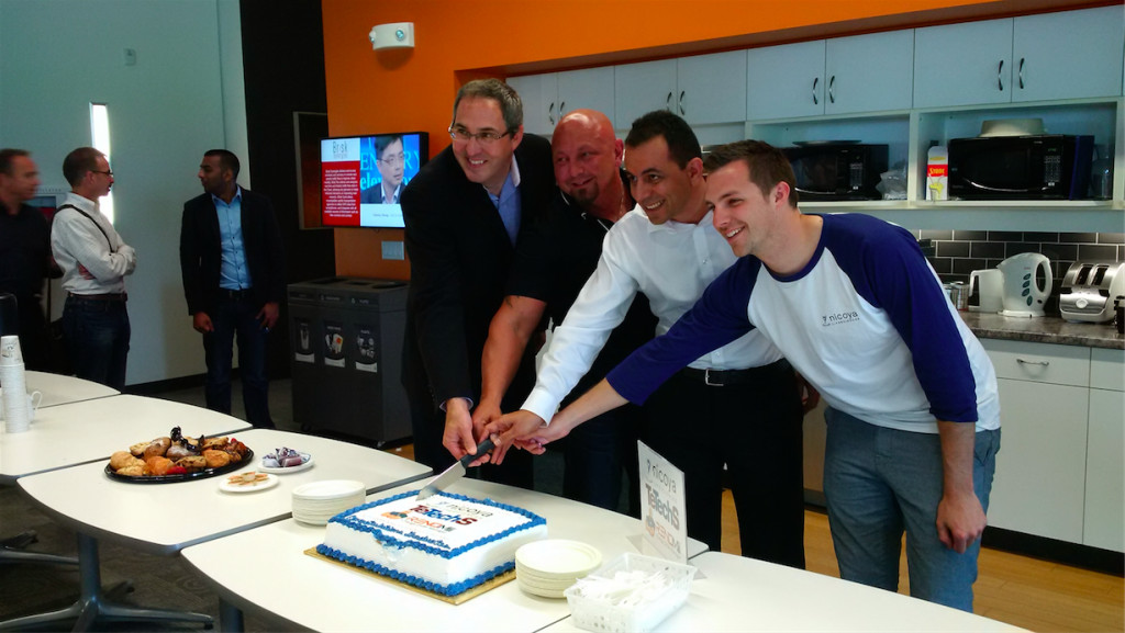 Nicoya and other graduates cutting a cake at the Accelerator Center
